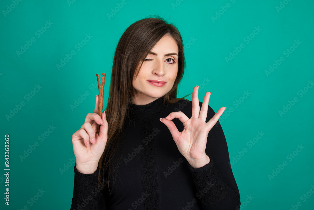 cinnamon concept girl holding and smelling cinnamon stick cinnamon concept girl holding and smelling cinnamon stick