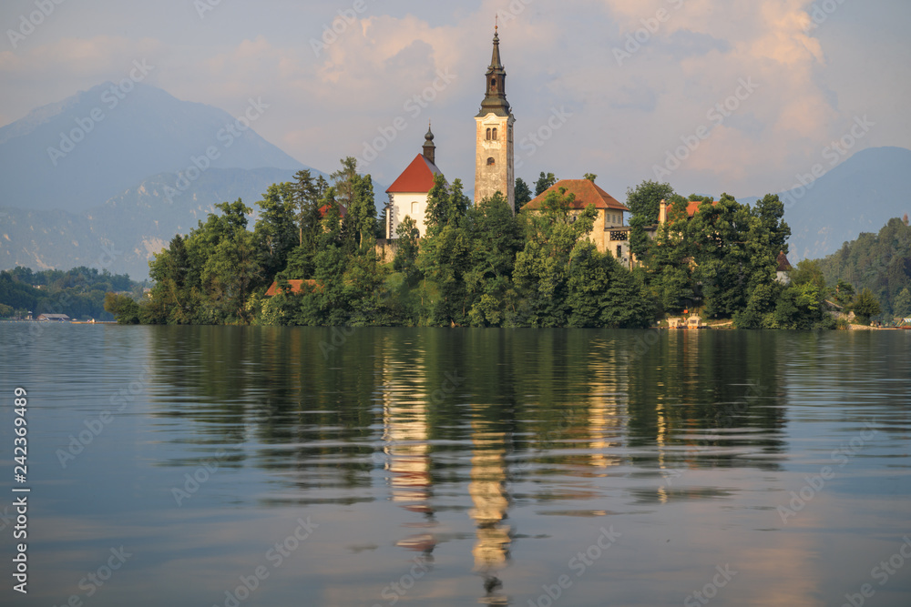 Amazing view of Bled Lake, Bled island with small pilgrimage Church of the Assumption of Maria, mountains on the background, Slovenia, Europe. Peace and quiet. Holidays in Slovenia.