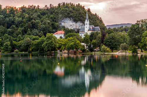 Lake Bled, Slovenia, in Alps mountains. Amazing view to the lake and and catholic church reflected in water at sunset. Travel Slovenia.