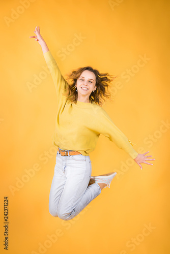 Girl in a jump on a yellow background