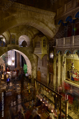 Interieur of the famous Jerusalem Church of the Holy Sepulchre with praying pilgrims, Israel 2018.