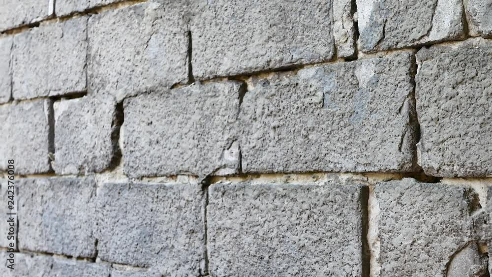 Old and torn surface of brick wall. Gray cement brick wall for background texture Old and torn surface of brick wall. Gray cement brick wall for background texture