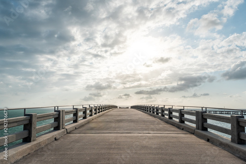 Old Bahia Honda Bridge Trail in state park during day in Florida Keys, with hiking path, nobody, sun behind clouds in sky, freedom concept