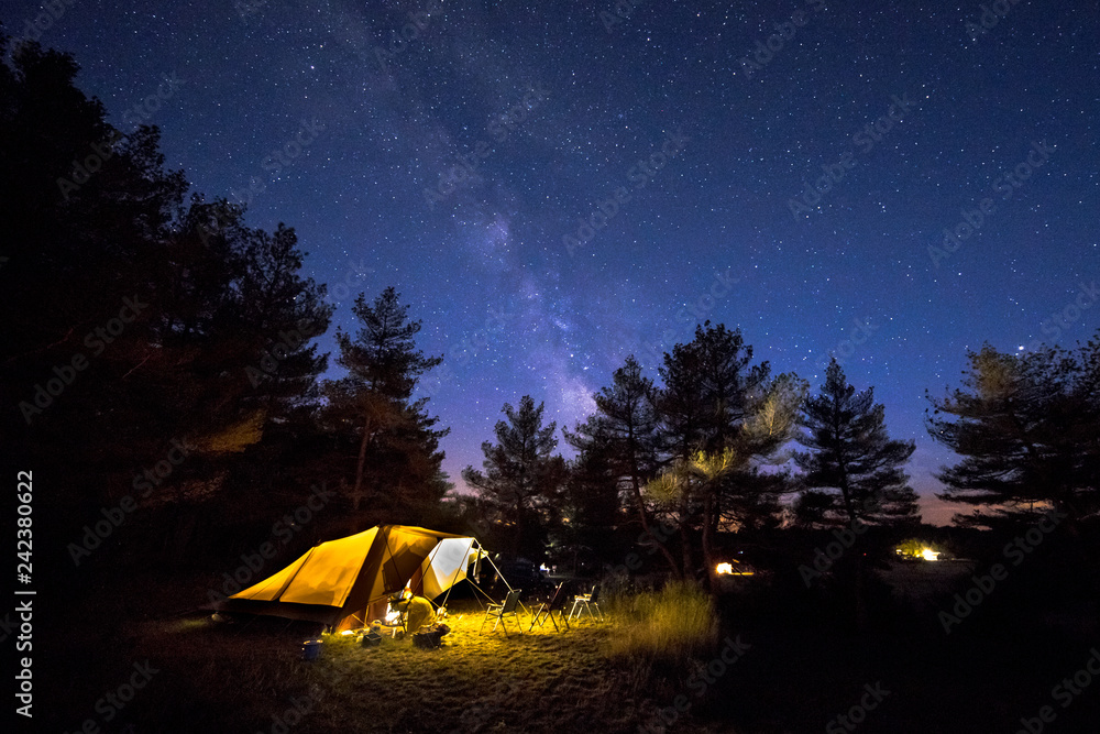 Family tent on camping ground under stars - obrazy, fototapety, plakaty 