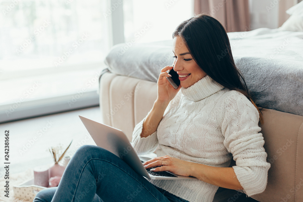 Woman working with laptop at home Woman working with laptop at home