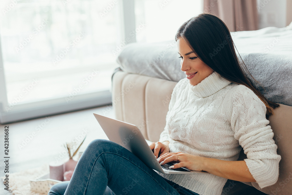 Woman working with laptop at home Woman working with laptop at home