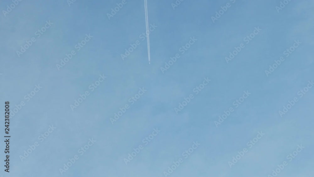 A long trail of jet in the blue sky. A long trail of jet in the blue sky.