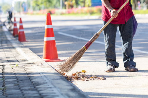 Man cleaning garbage on the road