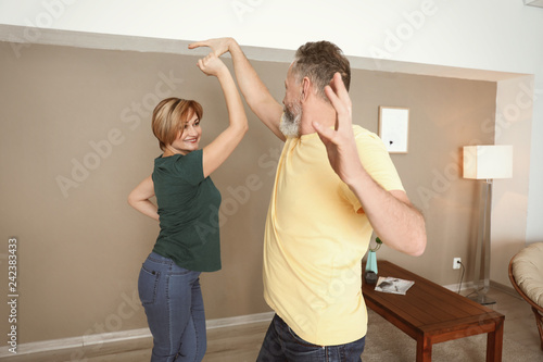 Happy mature couple dancing...