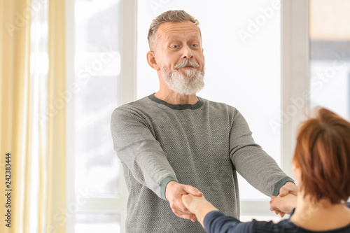 Happy mature couple dancing...