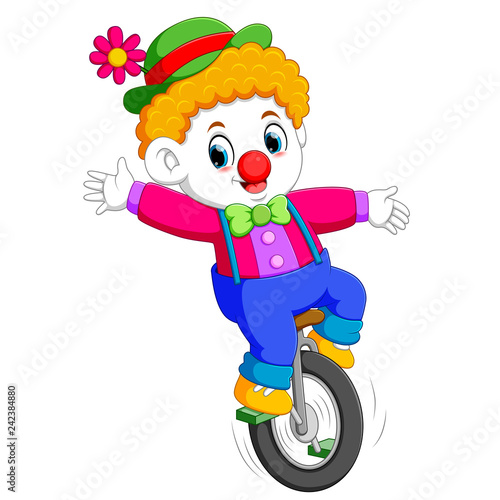 the boy uses the circus costume and standing on the unicycle