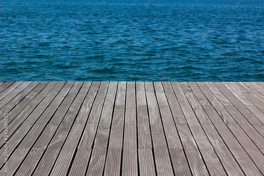 wallpaper pattern background surface texture of wooden deck floor perspective foreshortening and vivid blue sea water, empty space for copy or text wallpaper pattern background surface texture of wooden deck floor perspective foreshortening and vivid blue sea water, empty space for copy or text