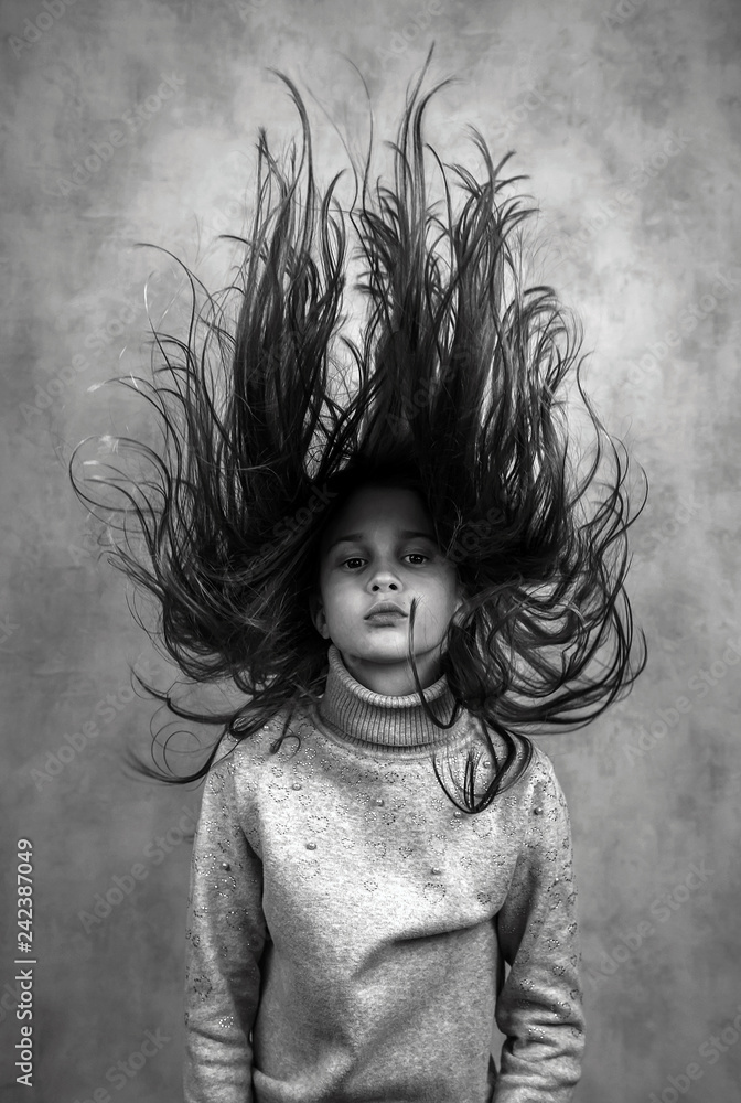 nice girl with an unusual hairstyle. Blast of hair. Stock Photo | Adobe Stock nice girl with an unusual hairstyle. Blast of hair. Stock Photo | Adobe Stock