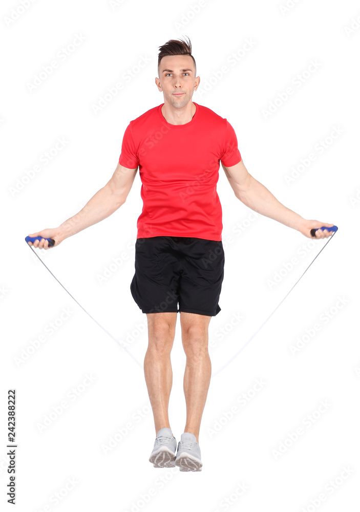 Full length portrait of young sportive man training with jump rope on white background Full length portrait of young sportive man training with jump rope on white background
