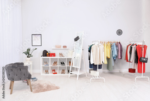 Light room interior with stylish clothes and shoes © New Africa