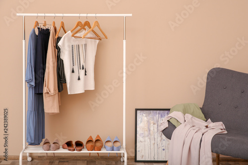 Wardrobe rack with female clothes in stylish dressing room © New Africa