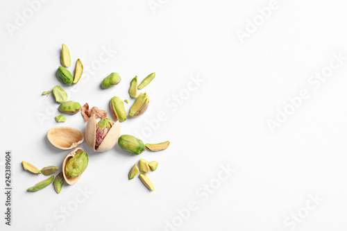 Composition with organic pistachio nuts on white background. Space for text