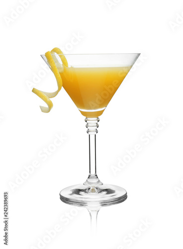 Glass of martini cocktail with lemon zest on white background