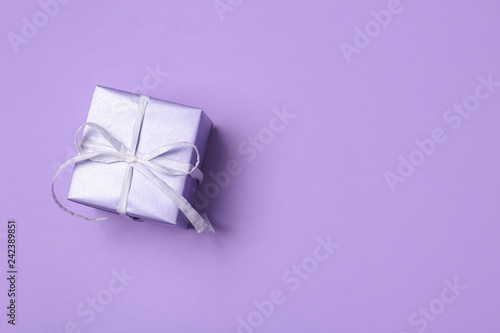 Beautiful gift box on color background, top view with space for text