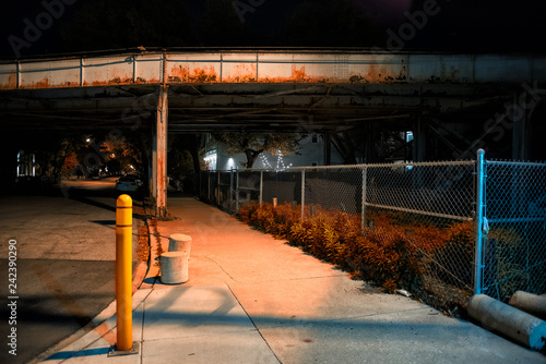 Scary and dark urban city industrial bridge with sidewalk at night in Chicago