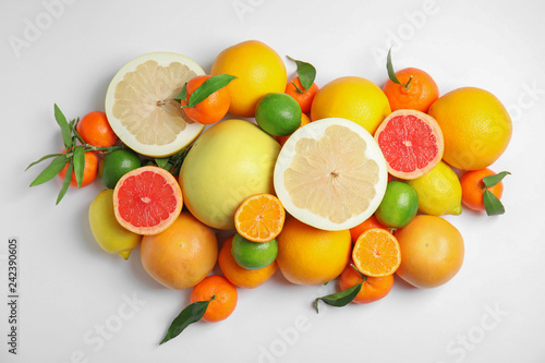 Different citrus fruits on white background, top view