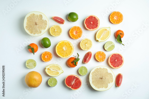 Fototapeta Naklejka Na Ścianę i Meble -  Different citrus fruits on white background, flat lay