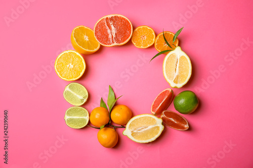 Fototapeta Naklejka Na Ścianę i Meble -  Frame made of different citrus fruits on color background, top view. Space for text