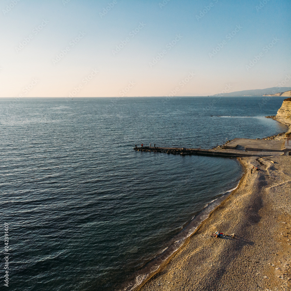 Aerial view of sea coast and old pier, summer ocean background with copy space