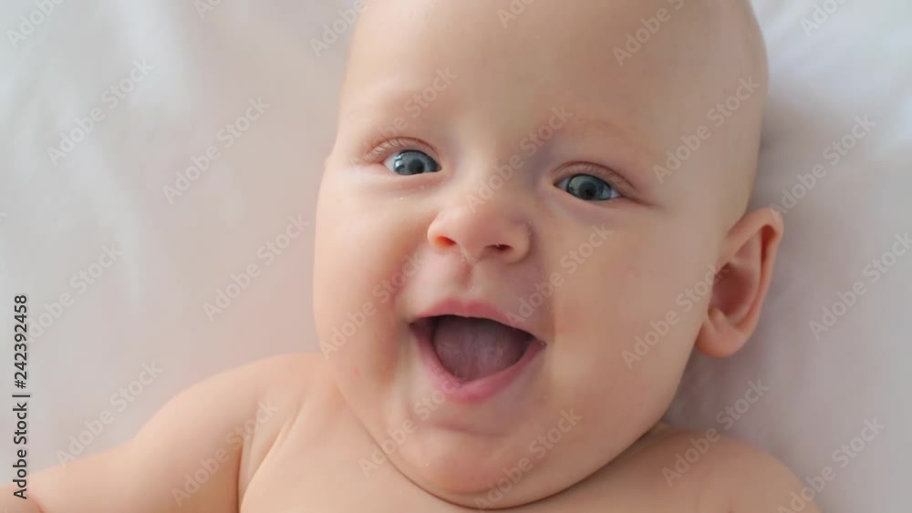 Close-up shot of lovely blue-eyed baby girl of six months old. Child face expression