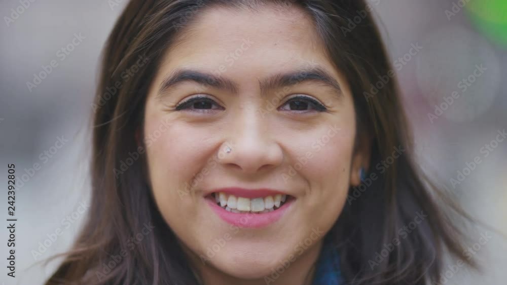 Portrait of happy young hispanic female smiling to camera Portrait of happy young hispanic female smiling to camera