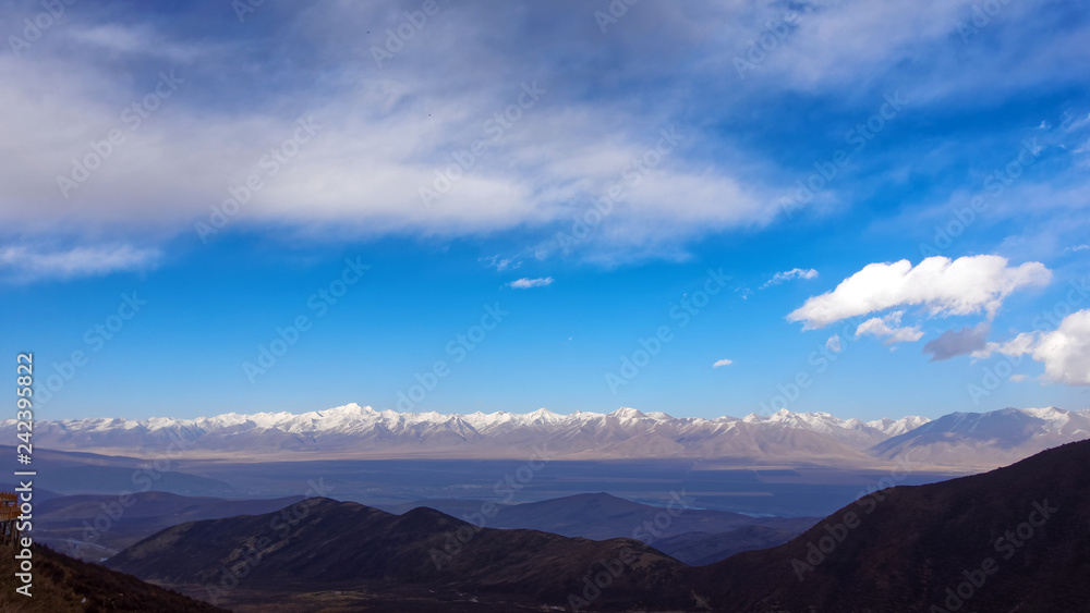 Panorama of Snow Mountain Range Landscape with Blue cloudy Sky in Gannan, Gansu, China. 