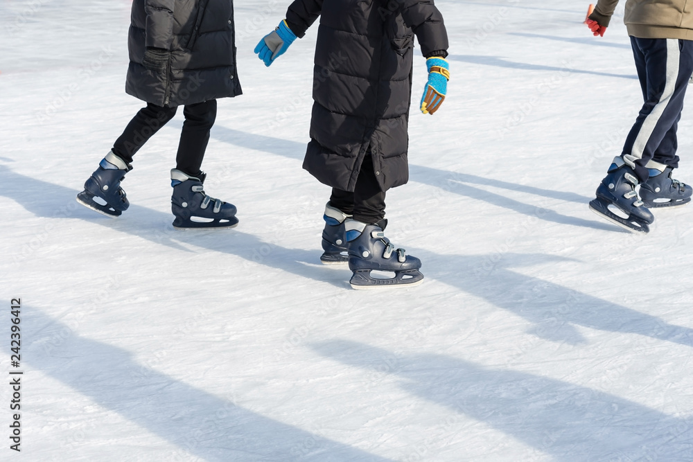 People ride on the skating rink on the ice rink during the Christmas holidays. Sports and fun pastime. People ride on the skating rink on the ice rink during the Christmas holidays. Sports and fun pastime.