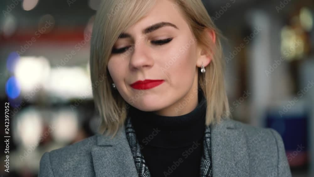 Portrait of a beautiful blonde girl with red lips. Slow motion Portrait of a beautiful blonde girl with red lips. Slow motion