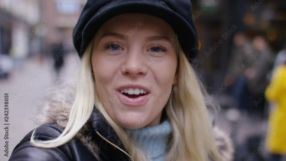 Young woman using her phone on a video call from a POV as she walks Young woman using her phone on a video call from a POV as she walks