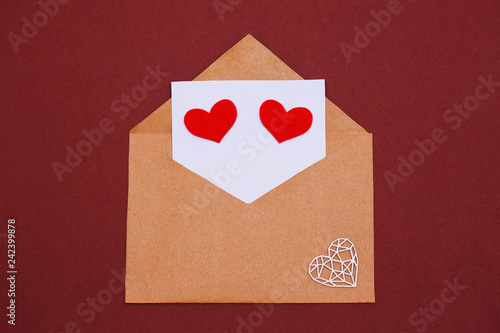 The 14th of February. Valentine's Day. Kraft paper envelope with a letter and eyes in the shape of hearts