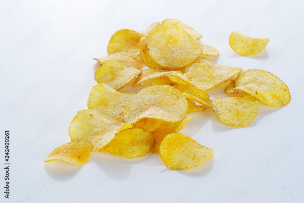 Potato chips scattered on a white background. Potato chips scattered on a white background.