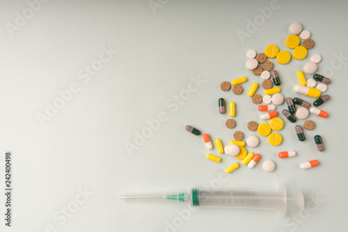 medicine Pills and disposable syringe closeup. Health pharmacy pharmacology concept with space for text