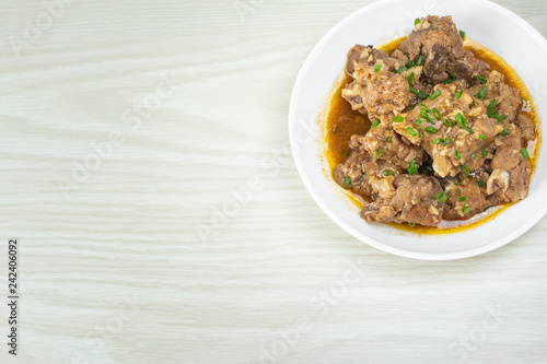 Chinese braised pork spare ribs with pepper and garlic sauce in white plate on the table