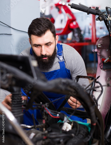 Worker repairing motorbike