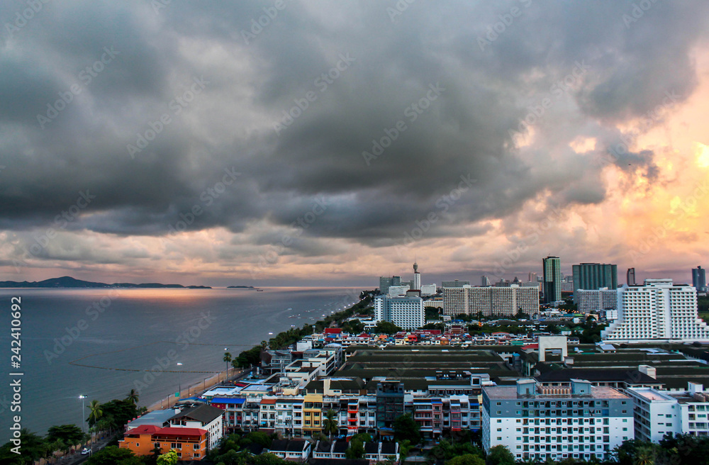 Obraz premium Top view of Pattaya town with the sea and build tower. Black cloud on sky