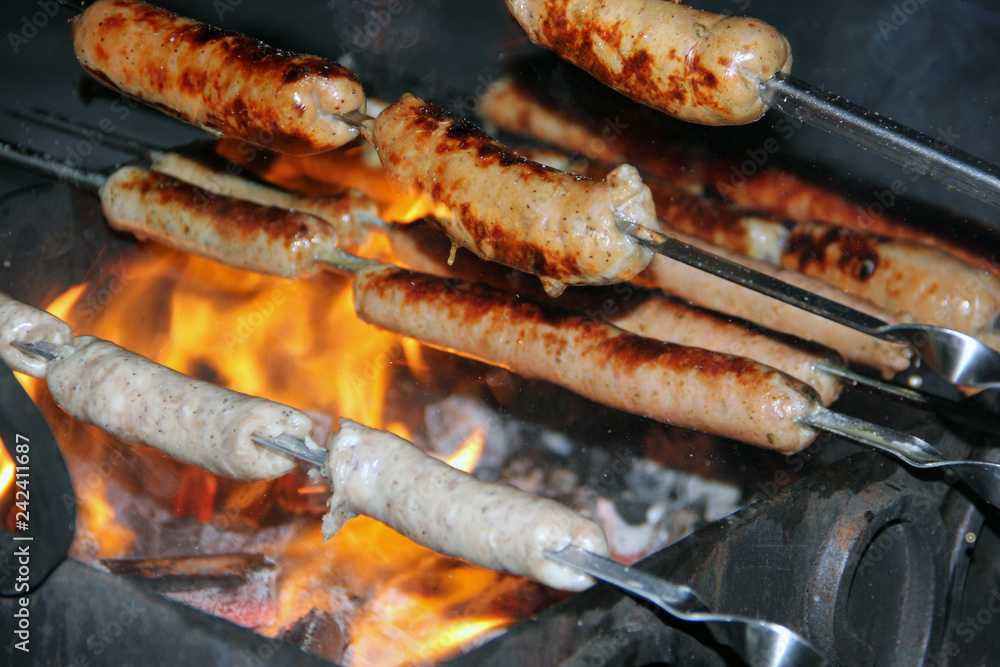 Grilled meat sausages, grilled pork sausages on grilled skewers, char-grilled sausages, sausage shashlik
