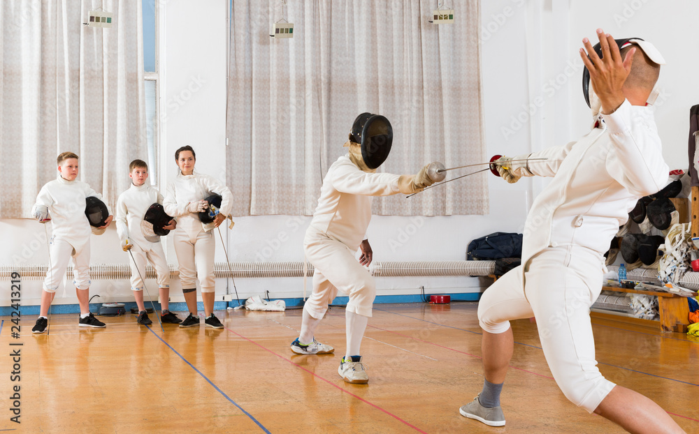 fencers looking at fencing duel