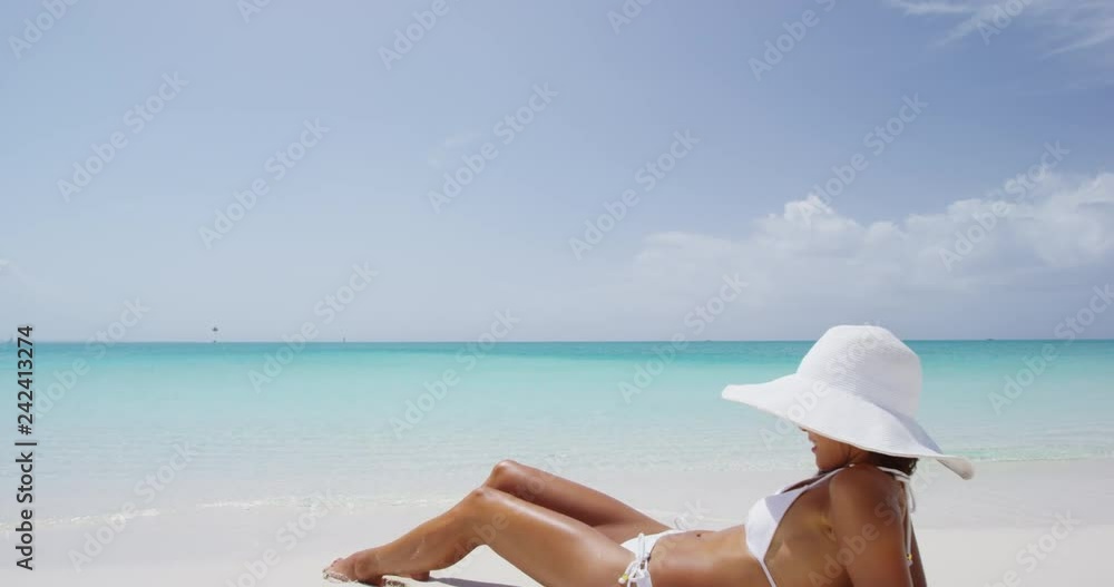 Sun tan woman in bikini sunbathing on beach vacation travel relaxing on Caribbean beach summer vacation travel destination. Sexy Asian woman with slim body for weight loss and holidays getaway concept Sun tan woman in bikini sunbathing on beach vacation travel relaxing on Caribbean beach summer vacation travel destination. Sexy Asian woman with slim body for weight loss and holidays getaway concept