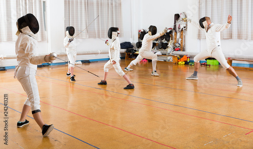 fencers training attack movements in pair
