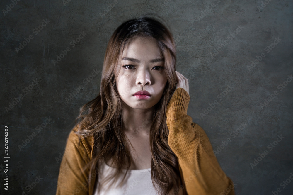sad and desperate Asian Korean woman looking depressed feeling helpless and pain on isolated dark background in pain face expression suffering depression sad and desperate Asian Korean woman looking depressed feeling helpless and pain on isolated dark background in pain face expression suffering depression
