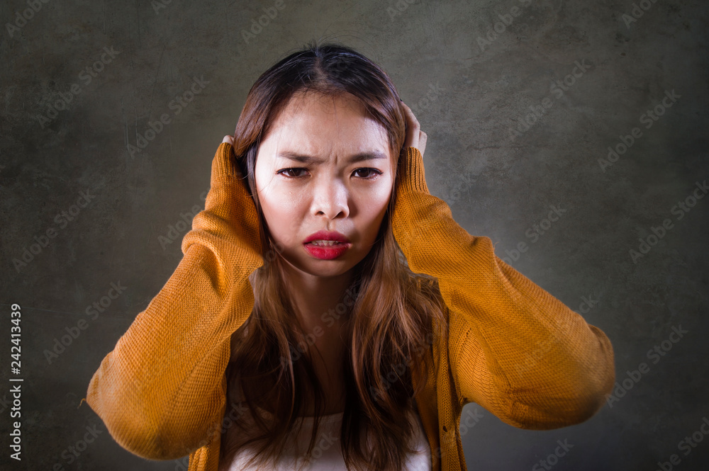 sad and desperate Asian Korean woman holding her head depressed feeling ...