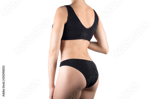 Female cropped fit body in black top and panties, isolated on white.