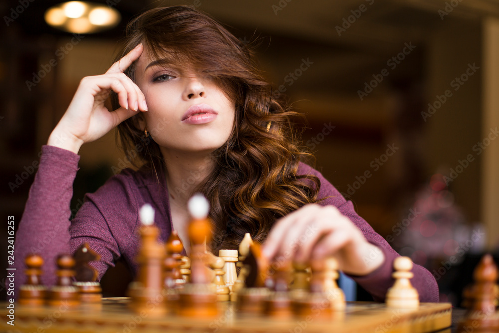 Focused woman thinking about next move and playing chess · Free Stock Photo