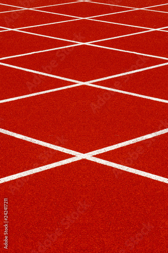 Red treadmill with white line at the stadium.