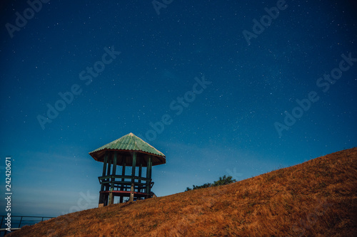 The scenic landscape of high mountains in the night with Pavilion, viewpoint foreground, on top viewpoint mountain. Location: Pui Kho mountain in Northern Thailand